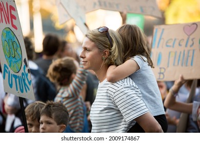 MELBOURNE, AUSTRALIA - May 21, 2021: Primary School Children With Their Parents March Down The Street Holding Signs Fighting For Climate Action  Student Climate Change Strike