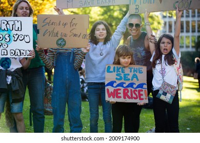 MELBOURNE, AUSTRALIA - May 21, 2021: Primary School Children With Their Parents Attending The Student Climate Change Strike  Kids Holding Signs Fighting For Climate Action