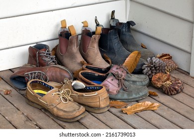 Melbourne, Australia - May 29, 2022:  A Collection Of Old Shoes And Boots For Walking And Working In The Garden At The Back Door Of A House In The Outer Suburbs Of Melbourne, Australia.