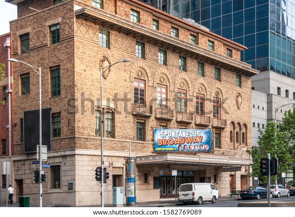 Melbourne, Australia - November 15, 2009: Brown\
brick facade with windows of The Comedy Theatre on intersection of\
Lonsdale and Exhibition streets. Spontaneous Broadway play\
announcement. Street\
scene