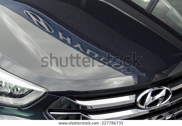 MELBOURNE,\
AUSTRALIA - November 2, 2014: details of a Hyundai car in a car\
dealership, with the dealer\'s sign reflected in the bonnet. Hyundai\
is a large South Korean car\
manufacturer.