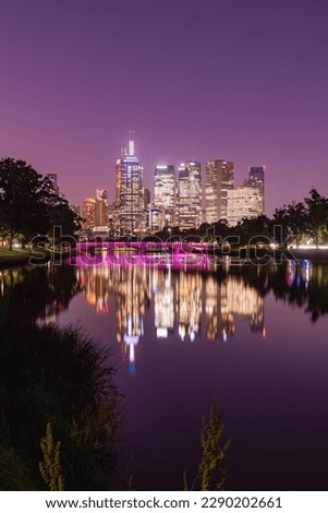 The Melbourne CBD skyline reflection over the Yarra River in front of a purple sunset 