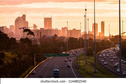 Melbourne City Skyline Above The Freeway At Sunset