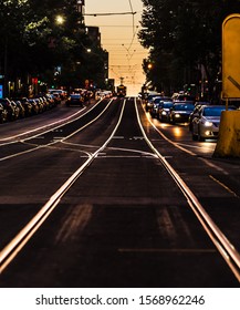 Melbourne City Tram Tracks Are Glowing In Golden Afternoon Sunlight With A Tram In The Distance