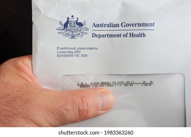 MELBOURNE - JUNE 01 2021:Australian Person Receiving Or Delivering A Letter From The Australian Government Department Of Health, Is In Charged On Australia Population Health Care.