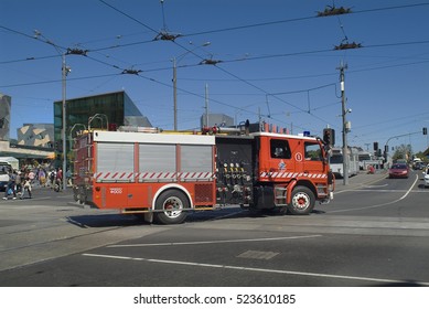 MELBOURNE, VIC, AUSTRALIA - NOVEMBER 09: Unidentified People And Fire Brigade Vehicle Crossing Flinders Street On Federation Square Area, On November 9, 2006 In Melbourne, Australia