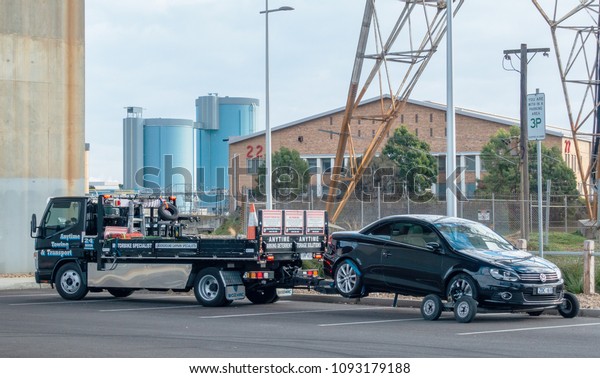 Melbourne, VIC Australia-May 10th 2018:\
Car being towed away by truck from a public car\
park.