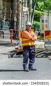 Melbourne, Victoria, Australia, 28th October, 2019: A City Council Road Worker Is Standing At The Back Of A Trailer Wearing High Visibility Clothing.