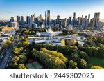 Melbourne, Victoria, Australia - April 14, 2024: Melbourne city skyline and Carlton Gardens with the Melbourne Museum and Royal Exhibition Building in the foreground.   