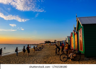 Melbourne, Victoria / Australia - April 15 2016: People Enjoy Relaxing Activities Hanging Out On The Beach With Friends And Family At Colorful Brighton Beach Bathing House In Melbourne Australia