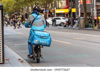 Melbourne, Victoria, Australia, April 17th, 2021: A Hungry Panda Food Delivery Motorcycle Driver Is On His Way To Deliver Food In The City Of Melbourne