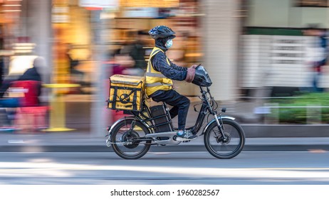 Melbourne, Victoria, Australia, April 17th, 2021: An EASI Food Delivery Motorcycle Driver Is On His Way To Deliver Food In The City Of Melbourne