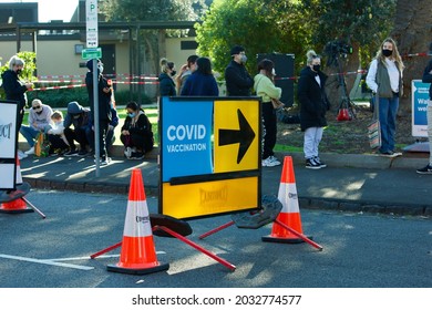 Melbourne, Victoria, Australia, August 30 2021: Covid Vaccination Sign. Queues Of People Waiting To Get Coronavirus Vaccine Outside Peanut Farm St Kilda Walk-in Covid-19 Vaccination Clinic. 