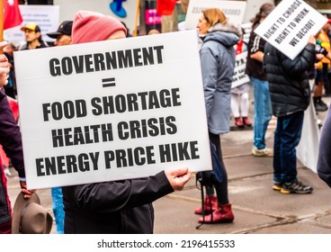 Melbourne, Victoria, Australia, August 6th, 2022: A Protestor Is Holding A White Protest Sign With An Anti Government Message During A Protest March Through The City