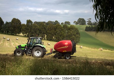 Melbourne, Victoria / Australia - Dec 11 2019:  A Farmer Harvesting Stock Feed In Afternoon Sunshine With A Straw Baler, In Neerim, Gippsland, Rural Victoria, Australia.