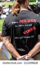 Melbourne, Victoria, Australia, January 15, 2022: A male protestor is wearing a “The Media is the Real Virus” Shirt as a symbol of protest during an anti vaccination march through the city.