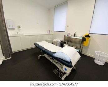 Melbourne, Victoria / Australia - June 1st 2020: An Examination Table In A Doctors Office Surgery With A Bench And A Trolley 