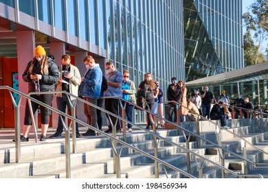 Melbourne, Victoria, Australia, June 3 2021: A Long Queue Of People Waiting To Get Vaccinated Against Covid19 At Melbourne Convention Centre Covonavirus Vaccination Hub. People In Line Wearing Masks.