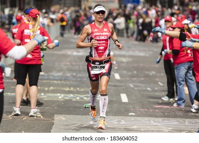 MELBOURNE, VICTORIA, AUSTRALIA - MARCH 23, 2014 - Caroline Steffen of Australia passes through an Aid Station during the Ironman run leg on March 23, 2014.