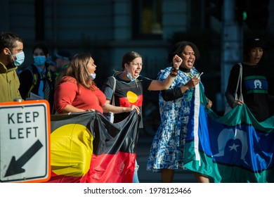 Melbourne, Victoria, Australia, May 21 2021: Indigenous Australians Holding The Aboriginal Flag On The City Streets At The Student Climate Protest. First Nations People Wearing Masks Protesting.