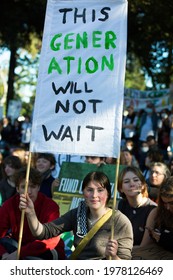 Melbourne, Victoria, Australia, May 21 2021: Group Of Student Protesters Striking For Climate Change Action Holding Signs And Banners And Wearing Covid19 Masks And School Uniforms.