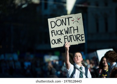 Melbourne, Victoria, Australia, May 21 2021: School child holding sign at strike, student climate change protest. Concerned boy with banner saying don't fuck with our future.