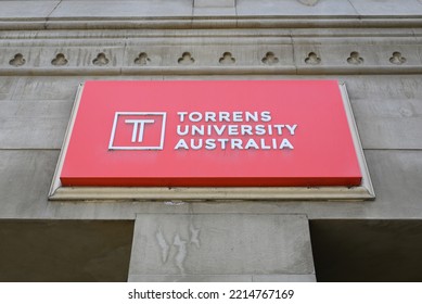 Melbourne, Victoria, Australia - October 16 2022: Red And White Torrens University Sign, Above The Entrance To Its Flinders St Campus, With Logo And Lettering Covered In Cobwebs