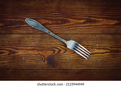 Melchior Fork On A Wooden Background