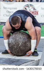 Melitopol, Ukraine, Date May 27, 2017, Strongman Raises A Heavy Stone Ball