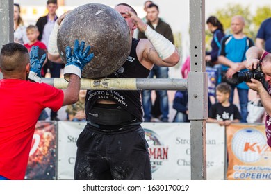 Melitopol, Ukraine, Date May 27, 2017, Strongman Throws A Heavy Ball Of Stone Through The Crossbar