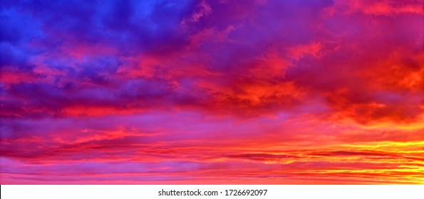 mellow sunset sky landscape background natural color of evening cloudscape panorama with sun below horizon ultra wide panoramic view of Red orange and blue colors of evening nature - Shutterstock ID 1726692097