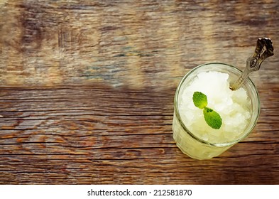 Melon Granita On Dark Wood Background. Tinting. Selective Focus On Mint