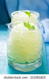 Melon Granita On Light Blue Background. Tinting. Selective Focus On Mint