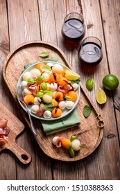 Melon, Mozzarella, Prosciutto Appetizer Or Snack, Salad With Cantaloupe Melon With Glasses Of Wine On Wooden Background Top View, Antipasti, Party Food, Skewer