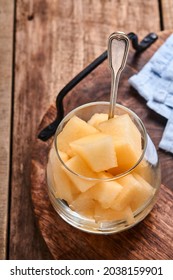 Melon. Pieces Of Fresh Melon For Making Fruit Dessert In Glass On An Old Wooden Background. Mock Up. Top View.