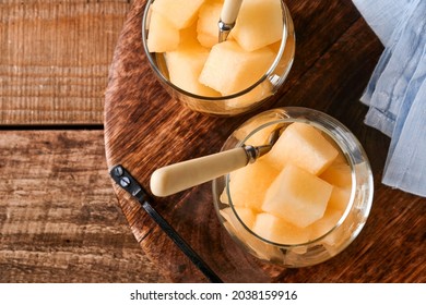 Melon. Pieces Of Fresh Melon For Making Fruit Dessert In Glass On An Old Wooden Background. Mock Up. Top View.