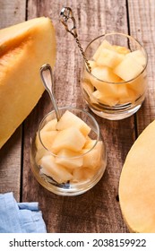 Melon. Pieces Of Fresh Melon For Making Fruit Dessert In Glass On An Old Wooden Background. Mock Up. Top View.