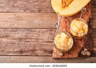 Melon. Pieces Of Fresh Melon For Making Fruit Dessert In Glass On An Old Wooden Background. Mock Up. Top View.