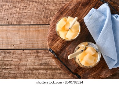 Melon. Pieces Of Fresh Melon For Making Fruit Dessert In Glass On An Old Wooden Background. Mock Up. Top View.