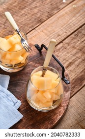 Melon. Pieces Of Fresh Melon For Making Fruit Dessert In Glass On An Old Wooden Background. Mock Up. Top View.