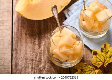 Melon. Pieces Of Fresh Melon For Making Fruit Dessert In Glass On An Old Wooden Background. Mock Up. Top View.