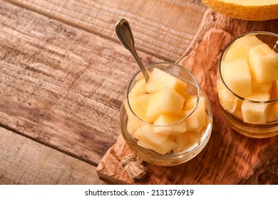 Melon. Pieces Of Fresh Melon For Making Fruit Dessert In Glass On An Old Wooden Background. Mock Up. Top View.