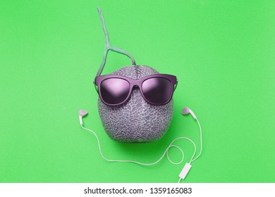 Melon With Sun Glasses And Headphone On Green Background, Summer Theme