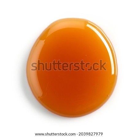 melted caramel drop isolated on white background, top view