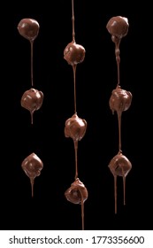 Melted Chocolat Candies Isolated On Black Background