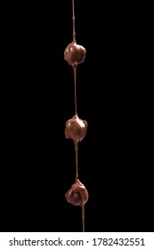 Melted Chocolat Candies Isolated On Black Background