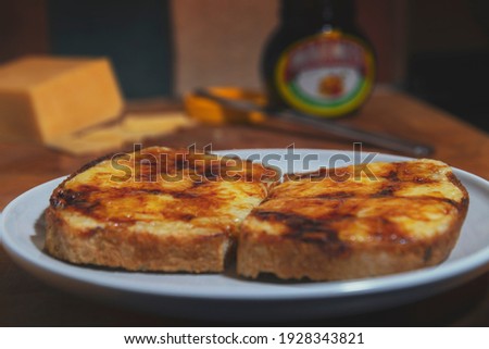 Melted grilled cheese on toast with yest extract spread