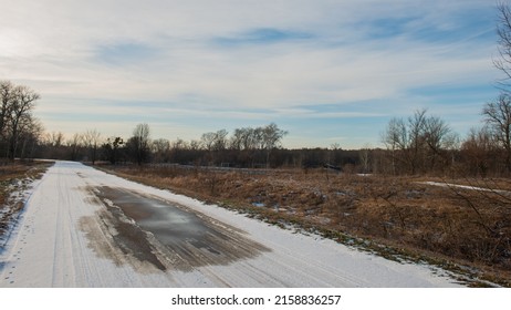 Melted snow on the asphalt road, thaw. Winter season. Web banner.