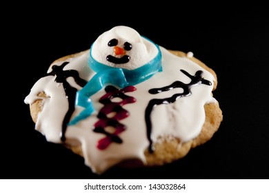 A Melted Snowman Cookie On A Black Background.