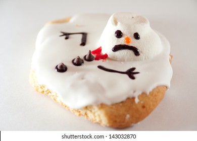 A Melted Snowman Cookie On A White Background.